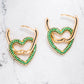 Gold tone earrings with heart shaped pendants in gold tone with emerald green coloured zircon stones.